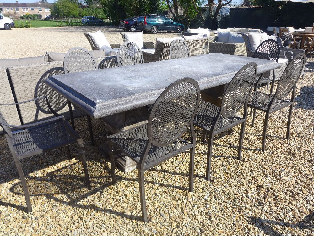 A Bramblecrest Venetian rectangular table with pedestal base with two metal armchairs and six metal