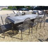 A Bramblecrest Venetian rectangular table with pedestal base with two metal armchairs and six metal