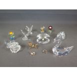 A group of eleven Swarovski crystal figures including larger swan, small swan, oyster, two