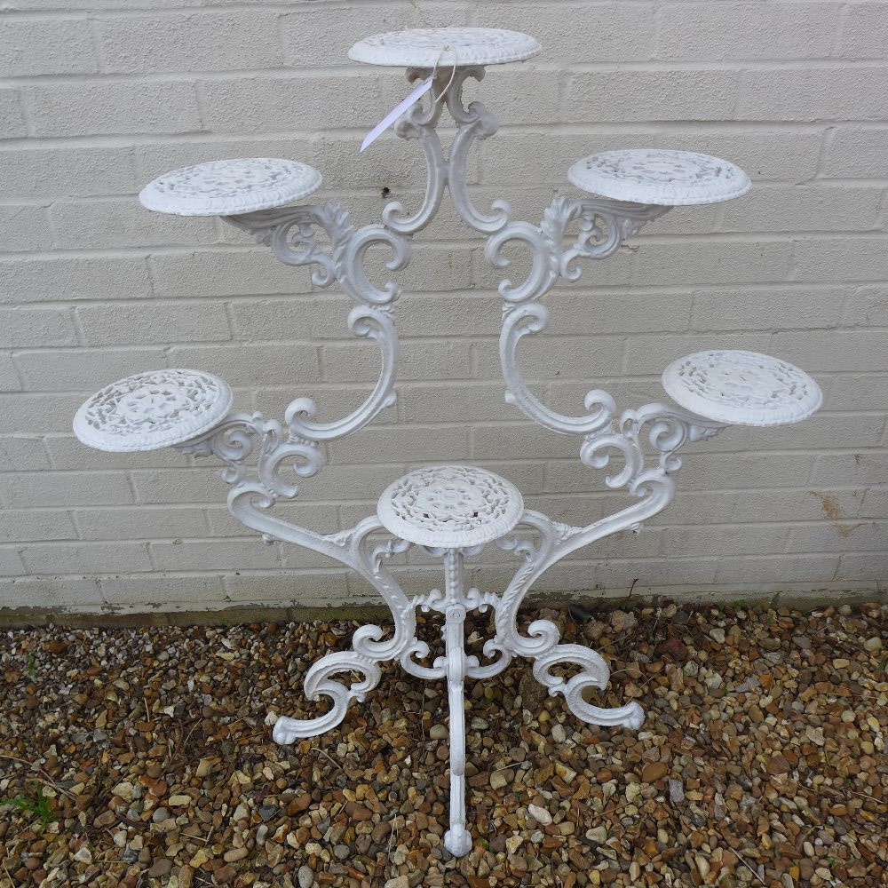 A cast iron white painted plant stand