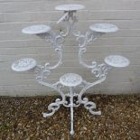 A cast iron white painted plant stand