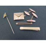 An assortment of items - To include a pair of cufflinks - A tie clip - A stamp holder pendant - A