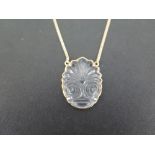 A Greek ILIAS LALAOUNIS carved rock crystal pendant - Suspended from a curb-link chain - Stamped