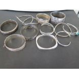 An assortment of twelve bangles - With marks indicating silver - Weight approx 7.9ozt