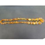 A string of amber  beads - Of assorted shapes and sizes - Length approx 68cms - Weight approx