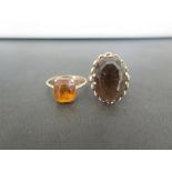 A smokey quartz single-stone ring - Together with an orange-gem ring - Both with marks indicating