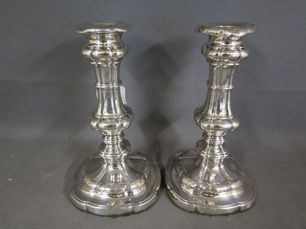 A pair of heavy silver plate or Sheffield plate silver candlesticks in the George III style -