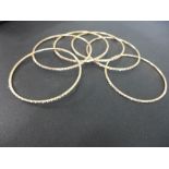 Six faceted bangles - Test as 14ct gold or above - Inner diameter 6.5cms - Weight approx