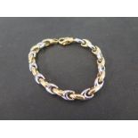 A bi-colour fancy-link bracelet - Stamped 750 - Length 19cms - Weight approx 17.0gms
Condition