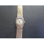 VERITY a ladies 9ct gold watch - The Arabic numerals to the textured strap - Hallmarked London -