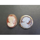 Two shell cameo brooches - Both stamped 750 - Diameter 2.8cms - Length 3.5cms (including pendant