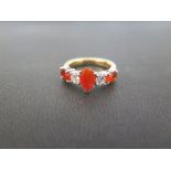 A diamond and fire opal five-stone ring - The pear and oval-shape fire opals to the brilliant-cut