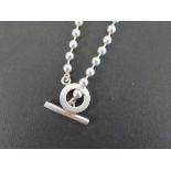 GUCCI  A silver bead necklace - With toggle and circle clasp - Hallmarked London - Length 40cms -