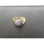 An 18ct gold brilliant and single-cut diamond cluster ring - With grooved line decoration to