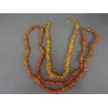 A string of dark Amber chip bead necklace - Length 106 cm - Weight approx. 38.5 grms and a string