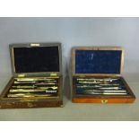 Two boxed rosewood veneers Geometry sets - both boxes with lift out tray, ivory pens etc.