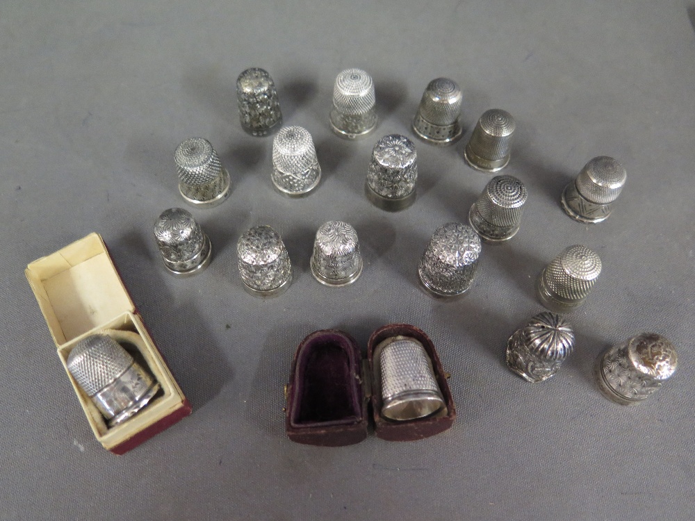A collection of thirteen silver thimbles and five plated thimbles