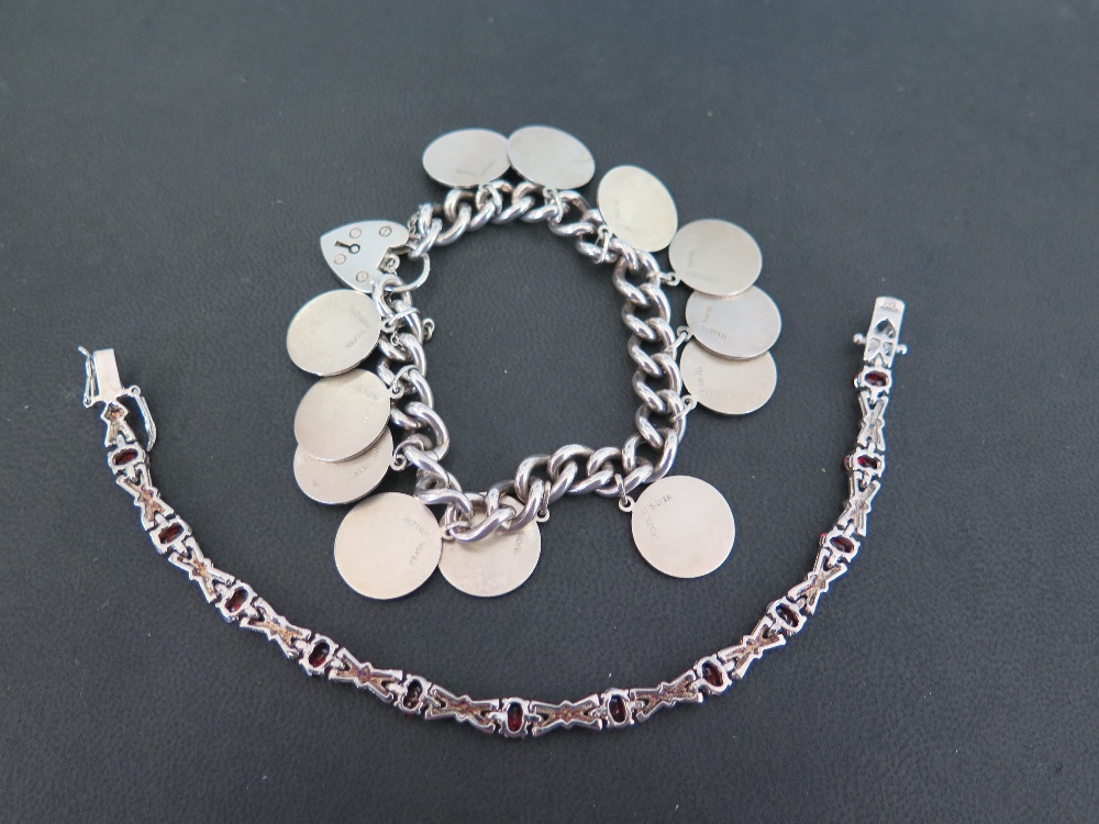 A silver curb-link bracelet - Suspending a series of charms depicting the signs of the zodiac - - Image 2 of 2