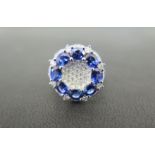 A sapphire and diamond cluster dress ring - The oval-shape sapphire circle to the pave-set diamond