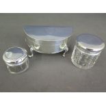 A silver trinket box and three silver top bottles