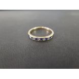 A 9ct gold sapphire and diamond channel-set ring - Hallmarked Birmingham - Ring size P - Weight