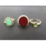 Three 9ct gold rings - To include a peridot single-stone, a green and white-gem cluster - Together