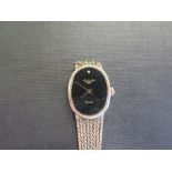 A Ladies 9 ct gold Longines wristwatch with 9 ct mesh strap with oval black face set with diamond