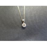 A 9ct gold diamond pendant - Hallmark obscured - Length 1cm - Suspended from a fine curb-link chain
