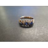 An 18ct gold sapphire and diamond ring - In a raised claw setting - Hallmarked Chester, 1925 - Ring