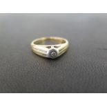 A diamond ring - With grooved line detail - Stamped 9ct - Ring size R - Weight approx