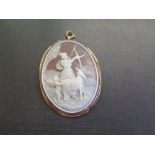 A shell cameo brooch pendant - Depicting Diana The Hunter, a cherub and a goat - Tests as 18ct gold