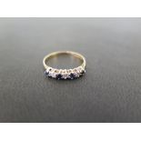 A 9ct gold sapphire and diamond seven-stone ring - Hallmarked Birmingham - Ring size L - Weight
