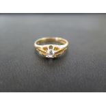 An 18ct gold diamond single-stone ring - The old-cut diamond within a raised claw setting to the