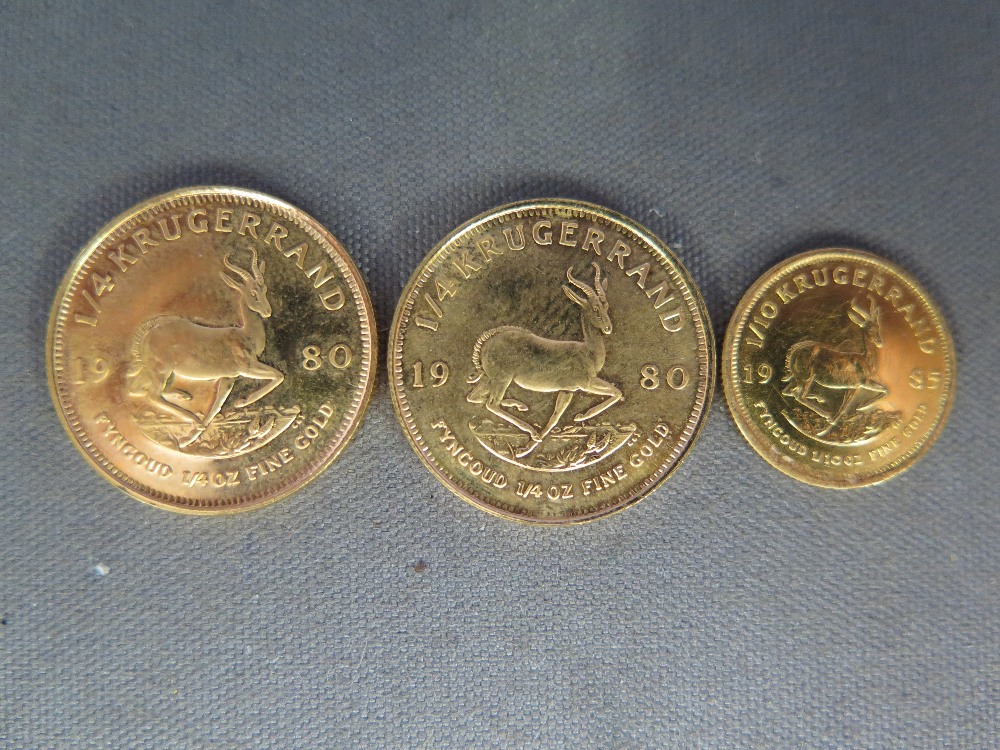 Two 1980 1/4 Krugerrand fine gold coins and a 1985 fine gold 1/10 Krugerrand