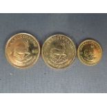 Two 1980 1/4 Krugerrand fine gold coins and a 1985 fine gold 1/10 Krugerrand