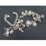 A silver charm bracelet and heavy silver curb bracelet plus loose charms - Weight approx. 4.5 troy