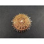 A star brooch/pendant - with faceted bead detail - Tests as 18ct gold - Diameter 4.5cms - Weight