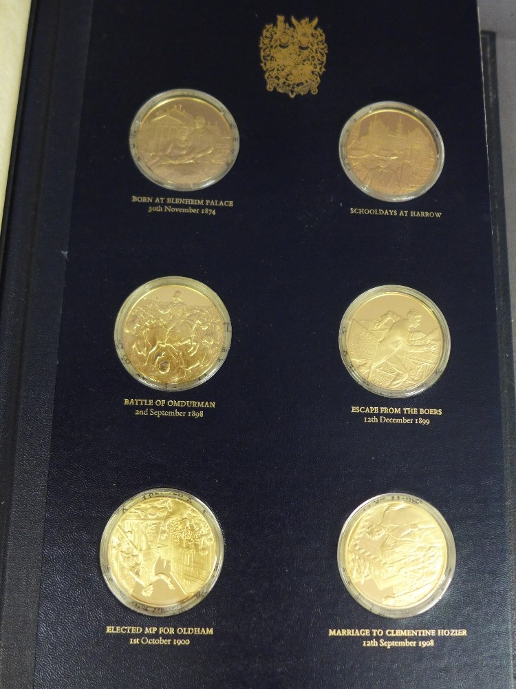 A folder containing twenty four 22 ct gold on silver Churchill Centenary medals no. 5023 - Weight