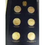 A folder containing twenty four 22 ct gold on silver Churchill Centenary medals no. 5023 - Weight