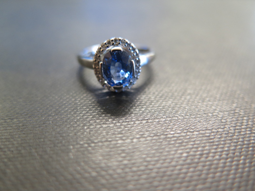 An 18ct gold sapphire and diamond cluster ring - Hallmarked Birmingham - Ring size L 1/2 - Weight