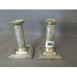 A pair of silver candlesticks A/F - Wrythen twist column stem, beaded decoration around base and