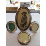 Three hallmarked silver circular picture frames and one larger oval hallmarked silver picture frame