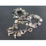 Three charm bracelets - With marks indicating silver - Weight approx 7.4ozt