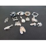 An assortment of silver and costume jewellery - To include rings, charms and a pair of earrings -