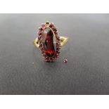 A garnet cluster ring - Stamped 9ct - Ring size W 1/2 - Weight approx 2.5gms
Condition Report: Fair