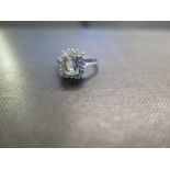 An 18ct gold paraiba tourmaline and diamond cluster ring - Hallmarked Birmingham - Ring size L -