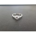 A diamond single-stone ring - The old-cut diamond to the tapered shoulders and plain band -