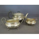 A silver hallmarked teaset - teapot, milk and sugar - teapot bearing hallmark for Sheffield 1956 -