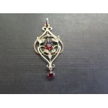 An early 20th century 9ct gold garnet topped doublet and seed pearl pendant - Length 4.5cms -