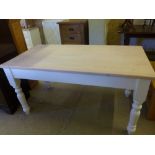 A large pine farmhouse table with drawer at one end,